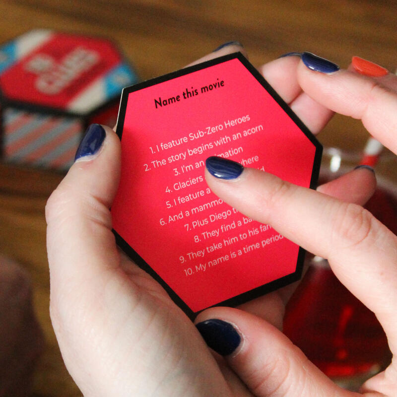 Close up of a hand holding a question card from Ginger Fox 10 Clues travel sized card game