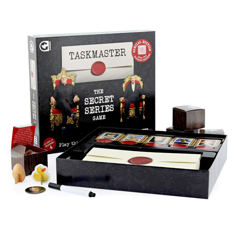 Taskmaster secret series board game box with lid off and contents showing on white background