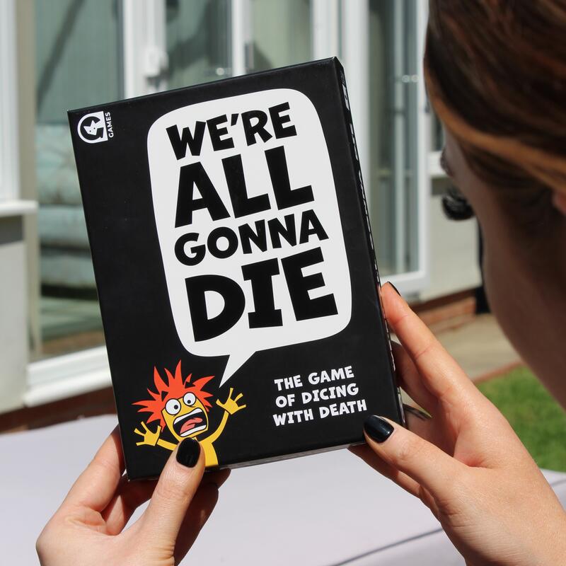 We Are All Gonna Die Game lifestyle box being held